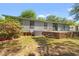 Backyard featuring a brick patio with steps leading to a well maintained lawn and mature landscaping at 976 South Marlin Circle, Murrells Inlet, SC 29576
