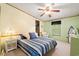 Bright bedroom with a ceiling fan, a bed with patterned bedding, and a walk-in closet at 976 South Marlin Circle, Murrells Inlet, SC 29576