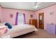 Bedroom featuring pink walls, two windows, a bed with neutral bedding, and carpet floors at 976 South Marlin Circle, Murrells Inlet, SC 29576