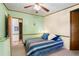 Sunny bedroom with a ceiling fan, a bed with patterned bedding, and carpet floors at 976 South Marlin Circle, Murrells Inlet, SC 29576
