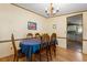 Cozy dining area with a chandelier and adjacent kitchen, perfect for Gathering meals at 976 South Marlin Circle, Murrells Inlet, SC 29576