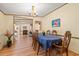 Traditional dining room featuring wood floors, a chandelier, and access to the living room at 976 South Marlin Circle, Murrells Inlet, SC 29576