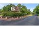 Community entrance sign with manicured landscaping and American flags welcoming residents at 976 South Marlin Circle, Murrells Inlet, SC 29576