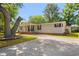 Well-maintained home featuring a long driveway, covered porch, and mature landscaping at 976 South Marlin Circle, Murrells Inlet, SC 29576