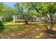 Charming home featuring a well-manicured lawn, a palm tree, and mature trees offering lots of shade at 976 South Marlin Circle, Murrells Inlet, SC 29576