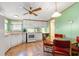 Corner kitchen featuring white cabinets, appliances, and countertops; featuring a ceiling fan and neutral accents at 976 South Marlin Circle, Murrells Inlet, SC 29576