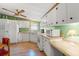 Bright kitchen with white cabinets, appliances, and countertops; featuring a ceiling fan and neutral accents at 976 South Marlin Circle, Murrells Inlet, SC 29576