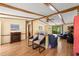 Open living space boasting exposed beam ceilings, hardwood floors, and an electric fireplace at 976 South Marlin Circle, Murrells Inlet, SC 29576