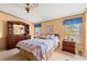 Comfortable bedroom featuring a ceiling fan, a dresser, and a bed with patterned bedding at 976 South Marlin Circle, Murrells Inlet, SC 29576