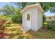 Storage shed featuring a side door and concrete ramp in a well-maintained backyard setting at 976 South Marlin Circle, Murrells Inlet, SC 29576