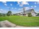 Expansive backyard with lush green lawn, views of the pond, and a covered patio for outdoor relaxation at 1001 Harvest View Ave., Conway, SC 29527
