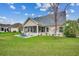 Exterior of a well-maintained home with a screened porch, green lawn, and manicured landscaping at 1001 Harvest View Ave., Conway, SC 29527