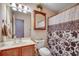 Well-lit bathroom featuring floral shower curtain, vanity with sink, and a wooden framed mirror at 1001 Harvest View Ave., Conway, SC 29527
