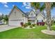 Charming home with a well-manicured lawn, attached garage, and mature landscaping and inviting curb appeal at 1001 Harvest View Ave., Conway, SC 29527