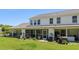 Spacious backyard with a screened patio, white siding, and lots of green space at 1004 Harvester Circle # 1004, Myrtle Beach, SC 29579