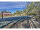 Community outdoor basketball court with bench seating surrounded by mature trees and lush landscaping at 1004 Harvester Circle # 1004, Myrtle Beach, SC 29579
