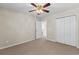 Carpeted bedroom with ceiling fan, closet, and neutral tones at 1004 Harvester Circle # 1004, Myrtle Beach, SC 29579