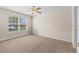 Carpeted bedroom with a ceiling fan and natural light coming in through a large window at 1004 Harvester Circle # 1004, Myrtle Beach, SC 29579