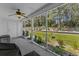 Enclosed porch with ceiling fan overlooks landscaped yard and greenery at 1004 Harvester Circle # 1004, Myrtle Beach, SC 29579