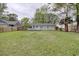 Spacious backyard featuring a deck and mature trees surrounding the well maintained lawn at 1028 1St Ave. S, North Myrtle Beach, SC 29582