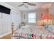 Bedroom features a ceiling fan, closet, window, and bright accents, creating a cozy retreat with ample storage and character at 1028 1St Ave. S, North Myrtle Beach, SC 29582