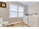 Bright laundry area featuring modern appliances, stylish wood floors and wainscoting detail for a clean, fresh aesthetic at 1028 1St Ave. S, North Myrtle Beach, SC 29582