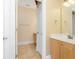 Bathroom featuring tile flooring, wood cabinets and a white-trimmed door at 106 Birch N Coppice Dr. # 2, Surfside Beach, SC 29575
