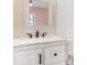 Bathroom featuring white vanity, a rectangular framed mirror and shiplap accent wall at 106 Birch N Coppice Dr. # 2, Surfside Beach, SC 29575