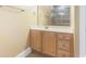 Bright bathroom featuring wood cabinets, white countertops and a large mirror at 106 Birch N Coppice Dr. # 2, Surfside Beach, SC 29575