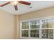 Bright bedroom with natural light from a large window and a modern ceiling fan at 106 Birch N Coppice Dr. # 2, Surfside Beach, SC 29575
