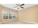 Spacious bedroom with neutral carpet, large windows, and a ceiling fan at 106 Birch N Coppice Dr. # 2, Surfside Beach, SC 29575