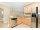 Modern kitchen features stainless appliances, granite counters, and tile floors at 106 Birch N Coppice Dr. # 2, Surfside Beach, SC 29575