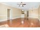 Open-concept living room features hardwood floors and a ceiling fan at 106 Birch N Coppice Dr. # 2, Surfside Beach, SC 29575