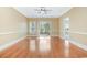 Bright living room with hardwood floors, a ceiling fan, and a sliding glass door to the outdoors at 106 Birch N Coppice Dr. # 2, Surfside Beach, SC 29575