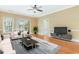 Bright living room with a ceiling fan, plush sofa set, and hardwood floors at 106 Birch N Coppice Dr. # 2, Surfside Beach, SC 29575