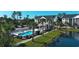 Aerial view of pool area with nearby buildings, landscaping and parking at 106 Birch N Coppice Dr. # 2, Surfside Beach, SC 29575