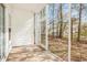 This screened porch features light-colored siding and a view of the backyard and trees at 106 Birch N Coppice Dr. # 2, Surfside Beach, SC 29575