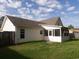 Home back view highlighting the vinyl siding, screened-in porch and fenced backyard at 108 Pickerel Blvd., Longs, SC 29568