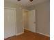 Bedroom showing a closet with paneled doors and access to another room, complete with hardwood floors at 108 Pickerel Blvd., Longs, SC 29568