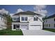 Charming two-story home with a three-car garage, classic siding, and a well-manicured lawn, providing a welcoming curb appeal at 1118 Laconic Dr., Myrtle Beach, SC 29588