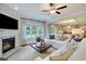 Spacious living room with fireplace, large windows, hardwood floors, and neutral decor opening to a dining and kitchen area at 1118 Laconic Dr., Myrtle Beach, SC 29588