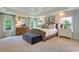 Luxurious main bedroom features neutral tones, large windows, and a tray ceiling for a tranquil retreat at 1118 Laconic Dr., Myrtle Beach, SC 29588