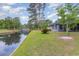 Lush backyard featuring a tranquil waterfront view in a peaceful setting at 112 Boxwood Ln., Conway, SC 29526