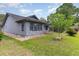 Well-maintained home exterior with a pergola-covered patio, lush green lawn, and mature landscaping, perfect for outdoor enjoyment at 112 Boxwood Ln., Conway, SC 29526