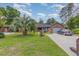 Charming brick home with an attached garage, long driveway, and green lawn at 112 Boxwood Ln., Conway, SC 29526