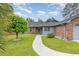 Charming brick home with well-manicured lawn and inviting walkway at 112 Boxwood Ln., Conway, SC 29526