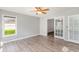 Open living room featuring wood-look flooring, bathed in natural light from large windows and complemented by fresh paint at 112 Boxwood Ln., Conway, SC 29526