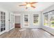 Bright living room with windows offering natural light, complemented by wood-look flooring and a ceiling fan at 112 Boxwood Ln., Conway, SC 29526