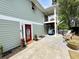 Back of house features a red door, covered porch, and outdoor seating area at 1131 Camellia Dr., Surfside Beach, SC 29575
