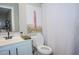 Bright bathroom offers a vanity with sink, toilet, shower with curtain, and unique artwork at 1131 Camellia Dr., Surfside Beach, SC 29575